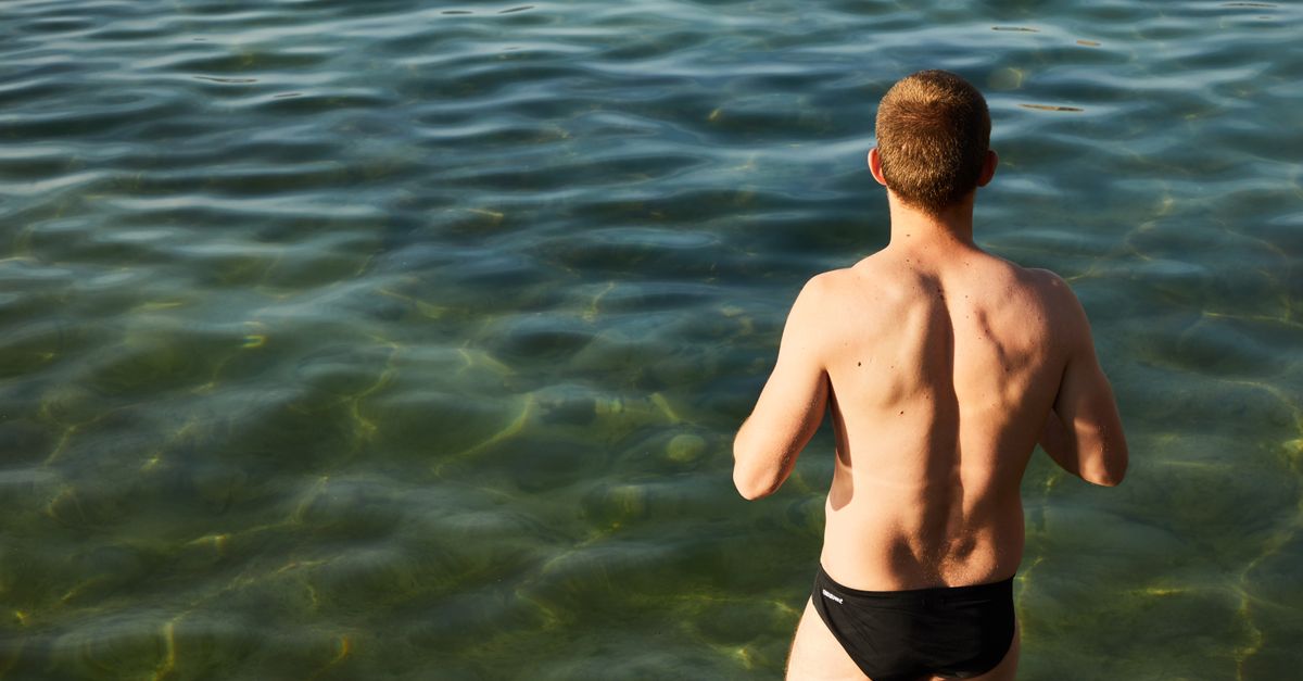 Man in swim trunks at the beach