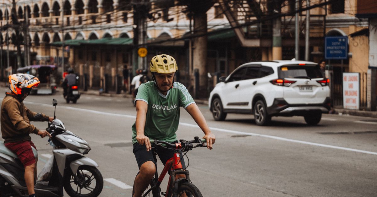 Cyclist wearing a helmet riding in the city