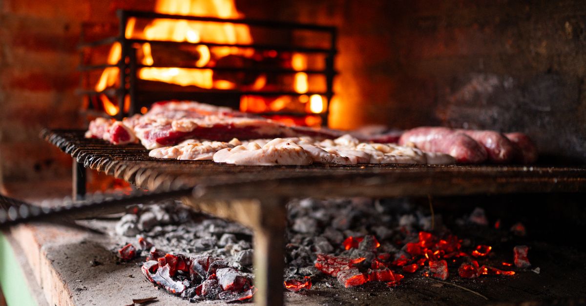 Meat grilling over coals at a barbecue